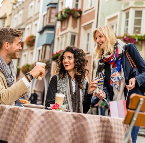 Two men and a woman are sitting at a table in the city of Sterzing
