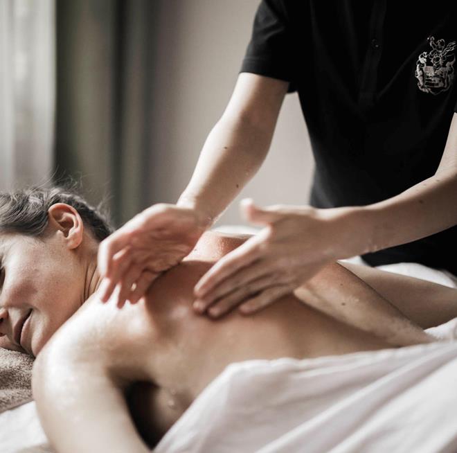 A woman is treating another woman with a massage