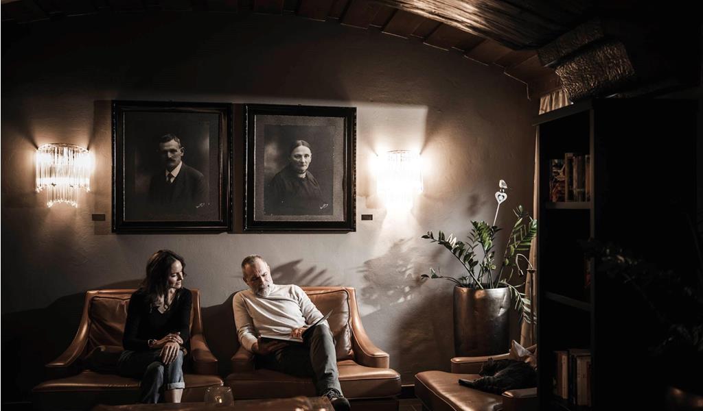 A man is sitting on a couch in the Stafler Hotel