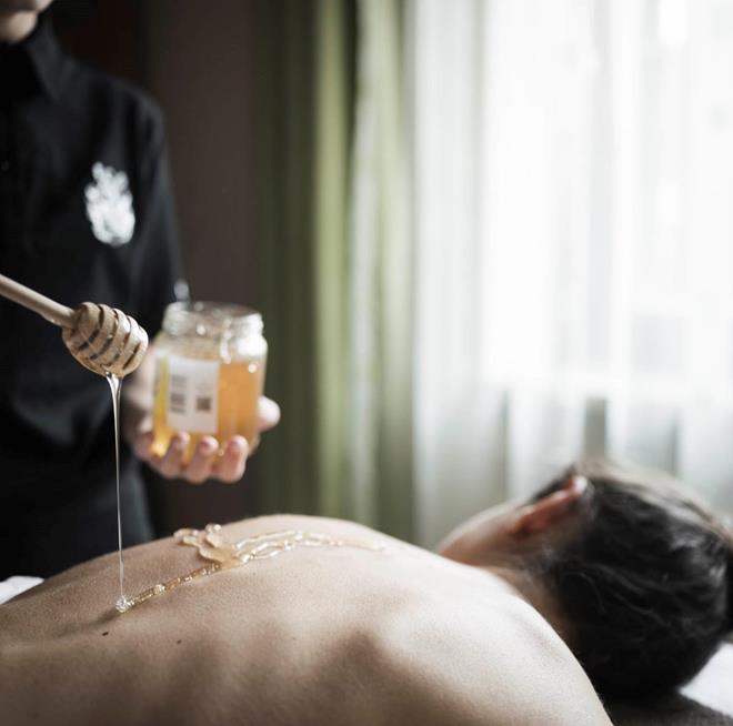 A woman is receiving a wellness treatment