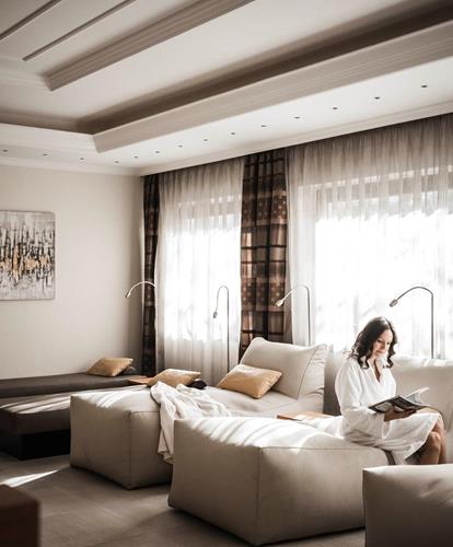 Una donna è seduta su una chaise longue nella sala relax