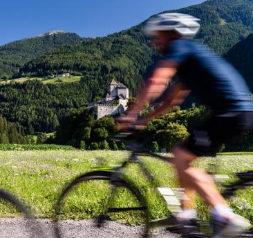 A man and a woman with bicycles on a bike path