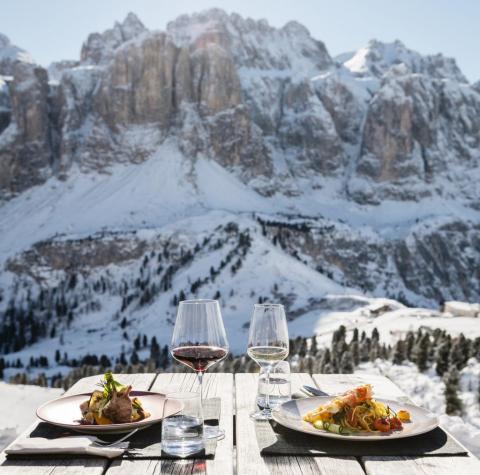 A set table in front of a snowy mountain backdrop