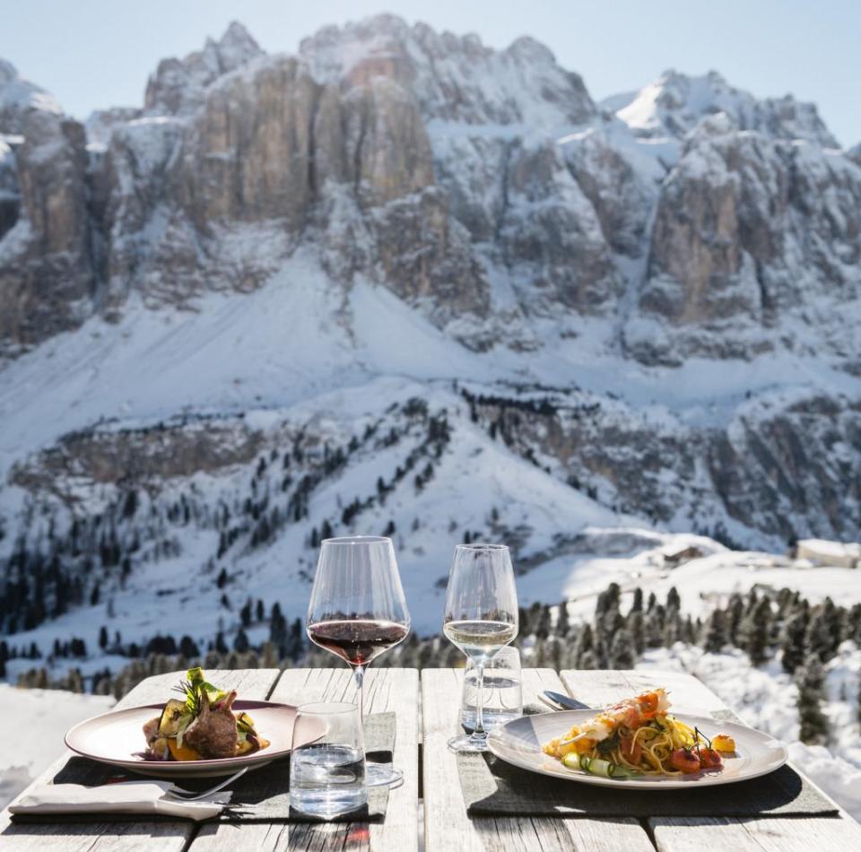 A set table in front of a snowy mountain backdrop