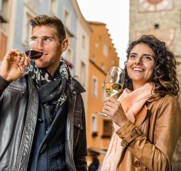 A man and a woman are drinking a glass of wine