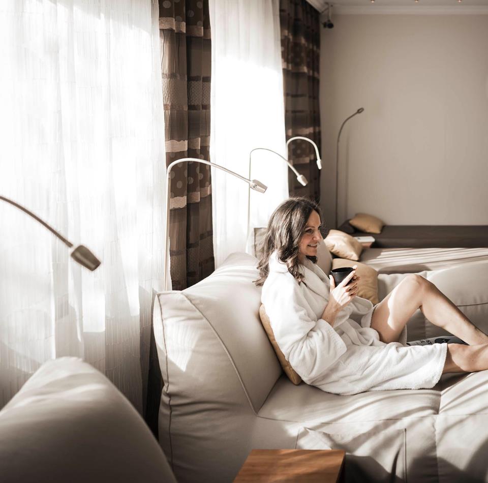 A woman is lying on a lounger in the relaxation room