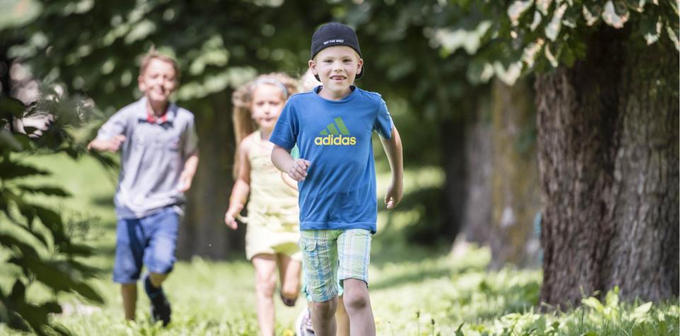Three children are playing in the garden