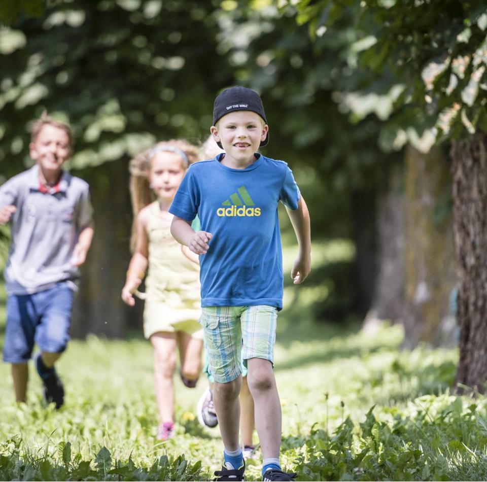 Three children are playing in the garden