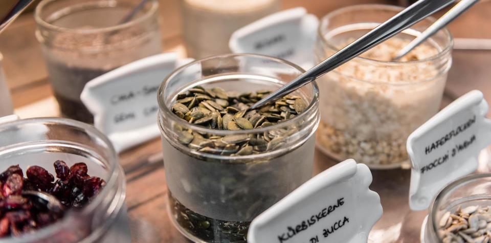 A glass bowl with pumpkin seeds