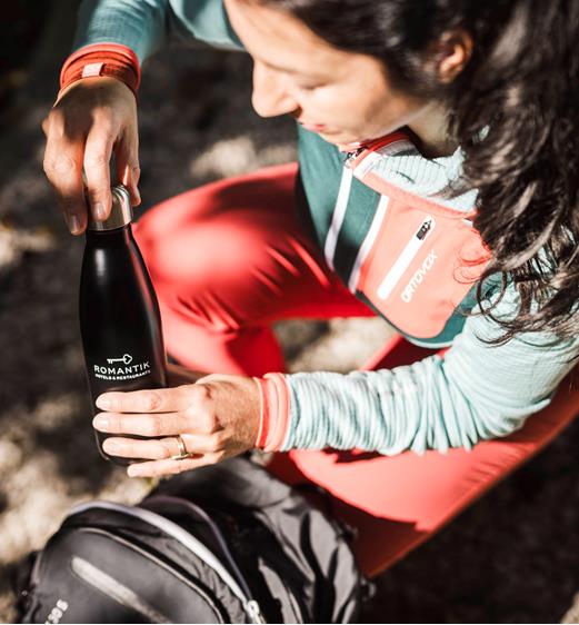 A woman takes a water bottle from her backpack