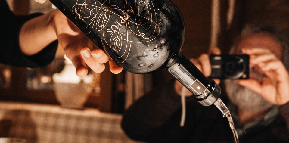 Una persona versa del vino
