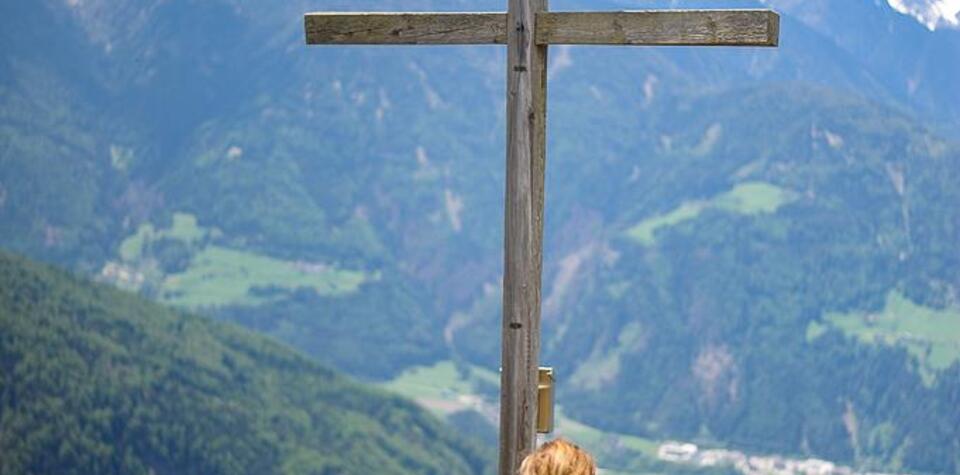 Woman with dogs at the summit cross