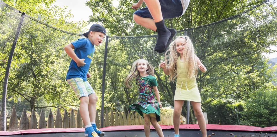Children are jumping on the trampoline