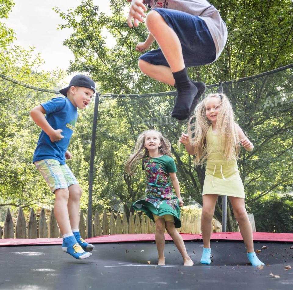 Children are jumping on the trampoline